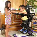 Siblings interacting and playing while brother stand in EasyStand Bantam.