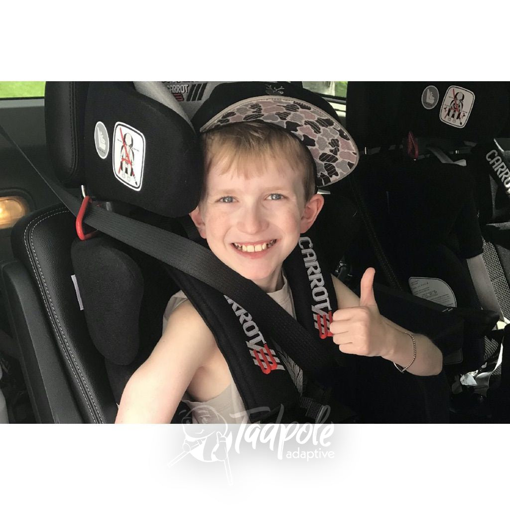 Kid in car backseat, giving his thumb's up in his Convaid Carrot 3 Special Needs Carseat.