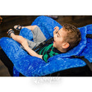 Little boy sitting while supported, watching TV in his P Pod Postural Support.