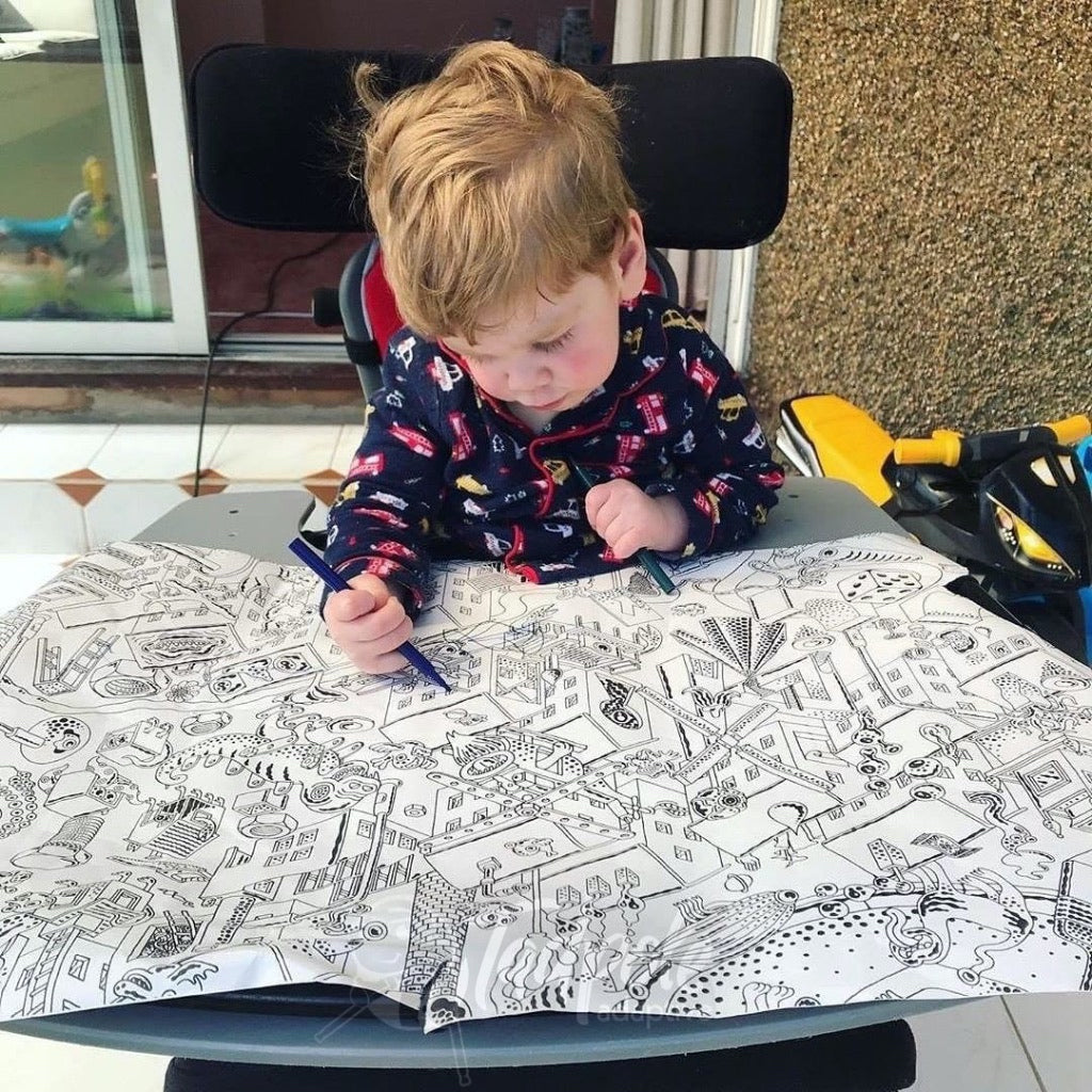 Young boy with large coloring paper using Jenx Junior Tray