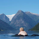 Boy in lake with mountain view in his Krabat special needs swimming aid.