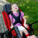 Little girl, sitting in Red Thomashilfen EASyS Advantage in reversed position.