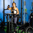 Young lady standing and excercizing in gym using EasyStand Evolv Glider.