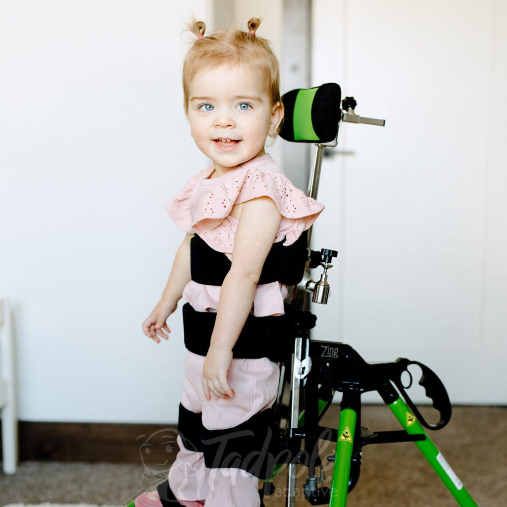 Young girl standing upright in the Easystand Zing Portable.