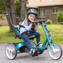 Child riding a Rifton Small Adaptive Bike with a helmet and glasses in a residential area.