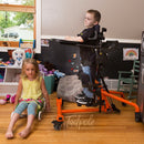 EasyStand Bantam Extra Small in orange,  Boy and sister in bedroom