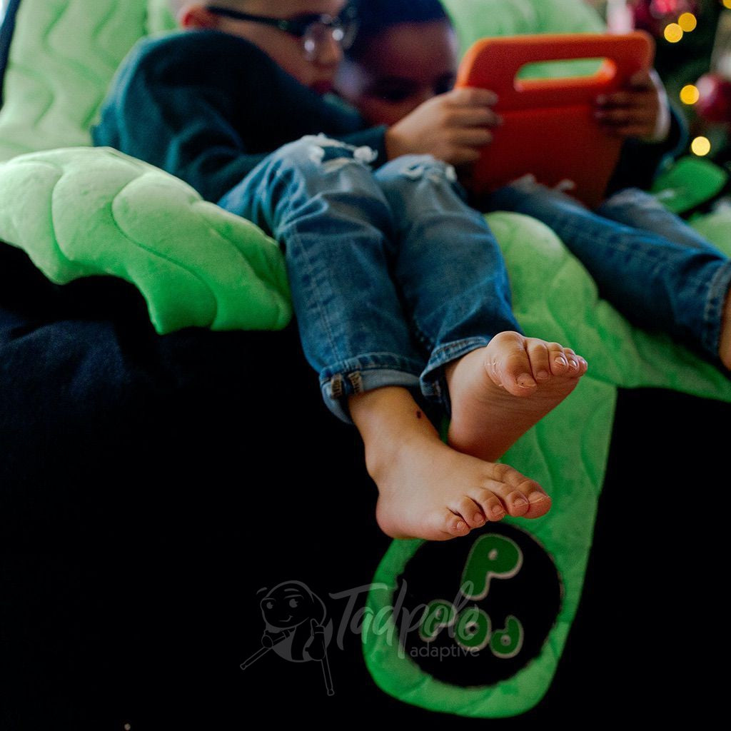 Brothers, with dangling feet by Christmas Tree, in their Green P Pod.