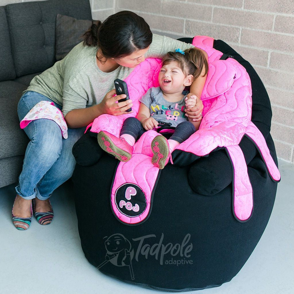 Mom and daughter interacting wile she site in her P Pod Chair in Mermaid Pink.