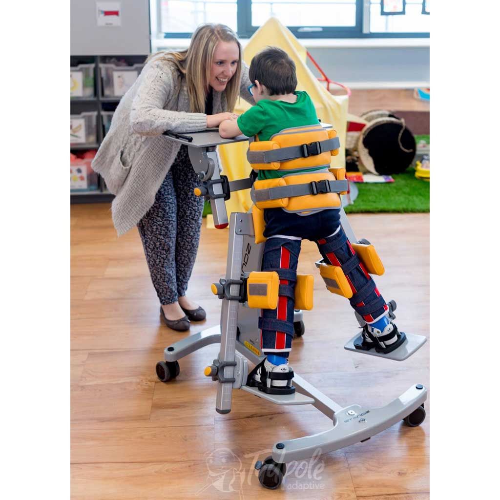 Young boy with therapist in his Jenx Standz Prone special needs stander.