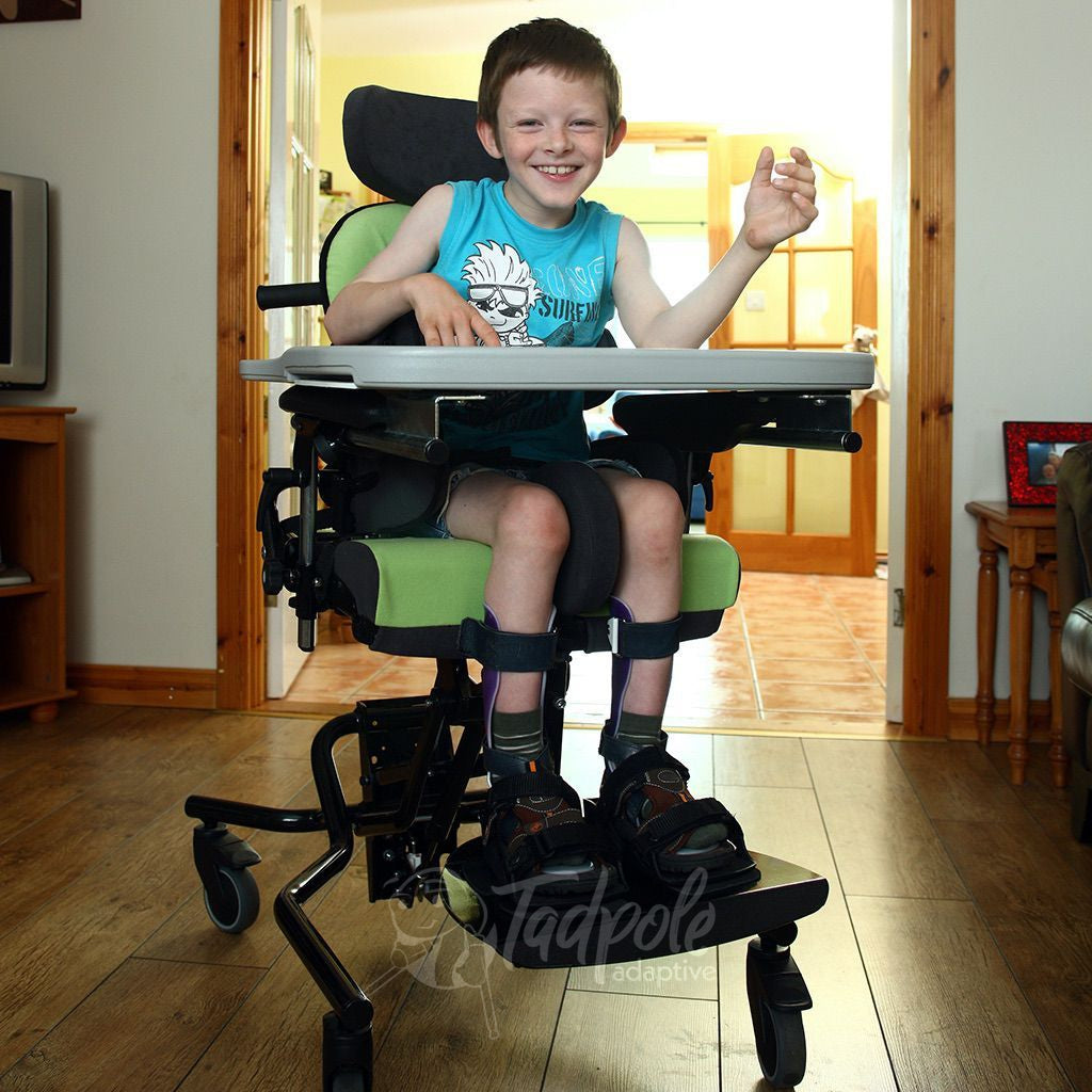 Young boy, at home, in his Green Leckey Everyday Activity Seat.