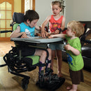 Boy, at home with his brother and sister playing while in his Leckey Everyday Activity Seat.