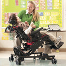 Little boy with teacher in his Rifton Large Activity Chair with Hi-Low Base.