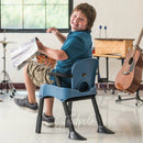 Boy in Rifton Compass Chair in classroom, featuring tip-proof legs.