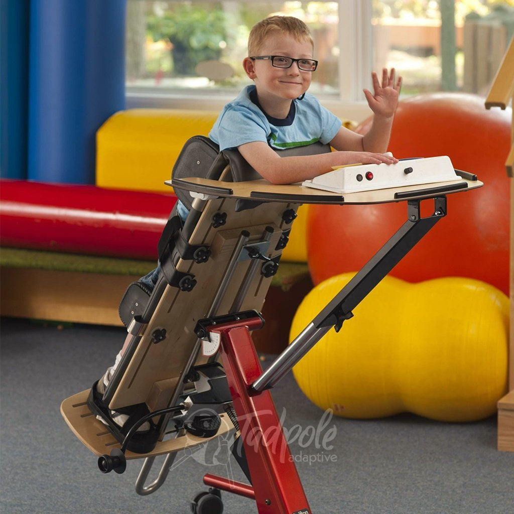 Young boy in classroom using the Rifton Prone Stander with Tray option.