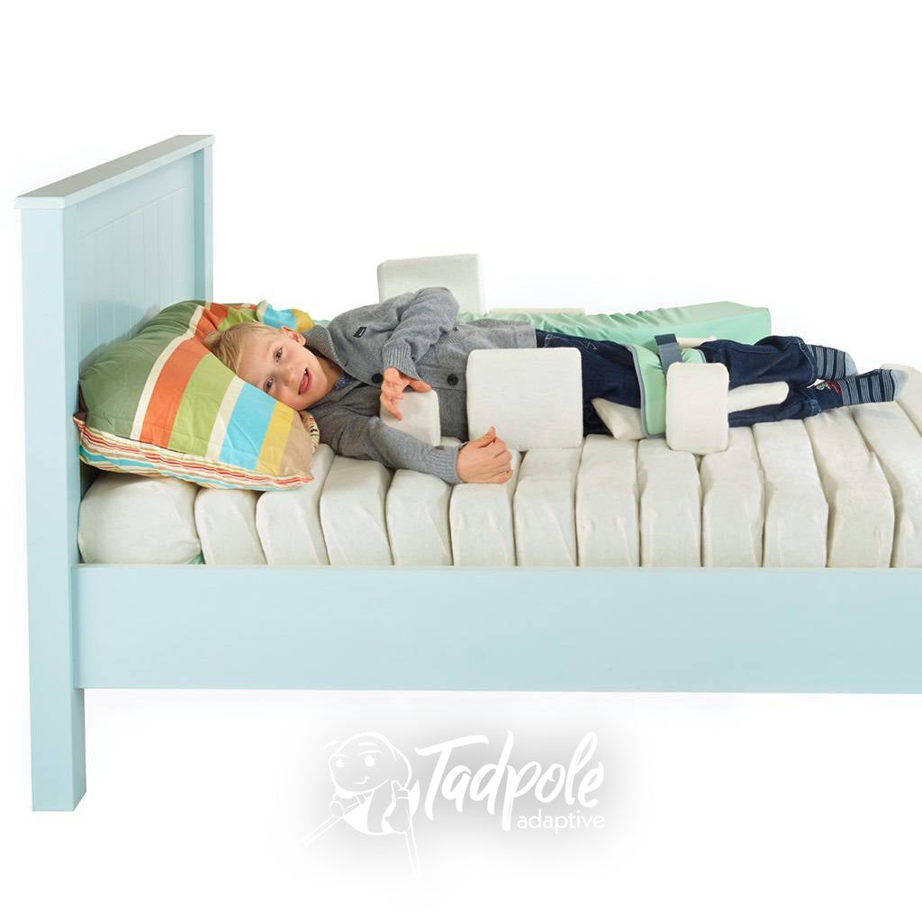 Young boy in bed, in his Jenx Dreama System, in side lying position.
